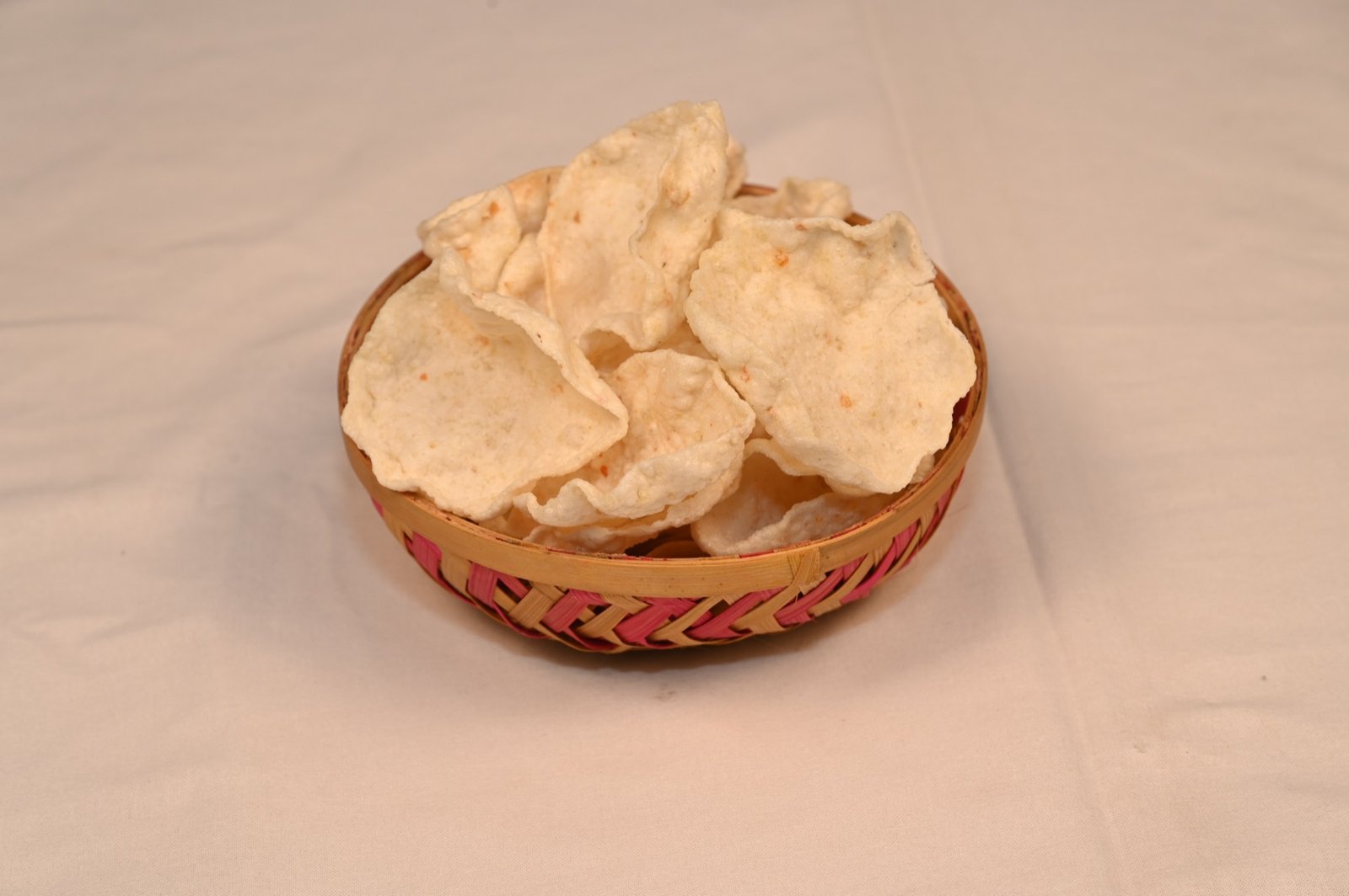 Light and airy Sena Foods Rice Papad in a woven serving basket